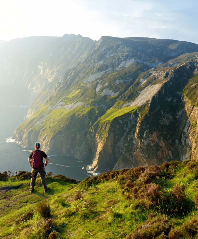 They stand at the top of a hill overlooking a body of water.