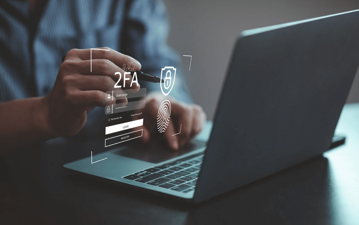 Person using a laptop with virtual graphics showing two-factor authentication, password entry, fingerprint scan, and security icons.