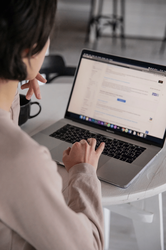 A woman using a laptop on a table.