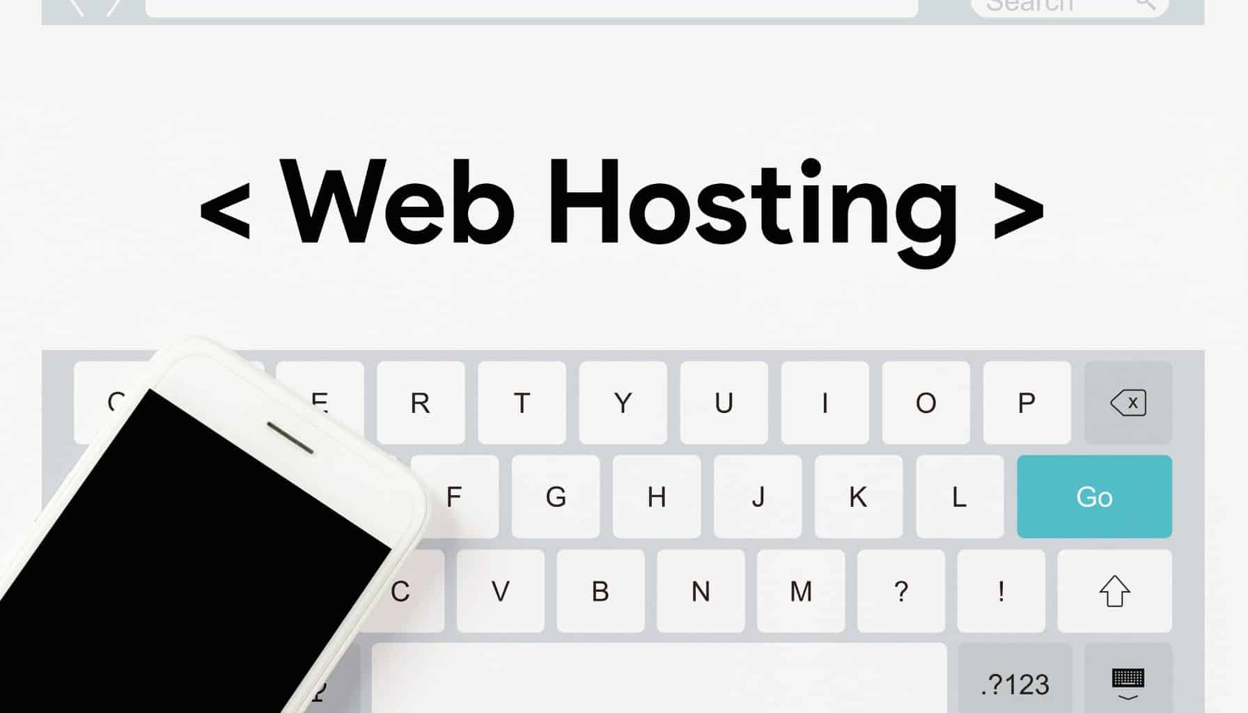 An iPhone rests on a keyboard with the words "Web Hosting" displayed on the screen above.