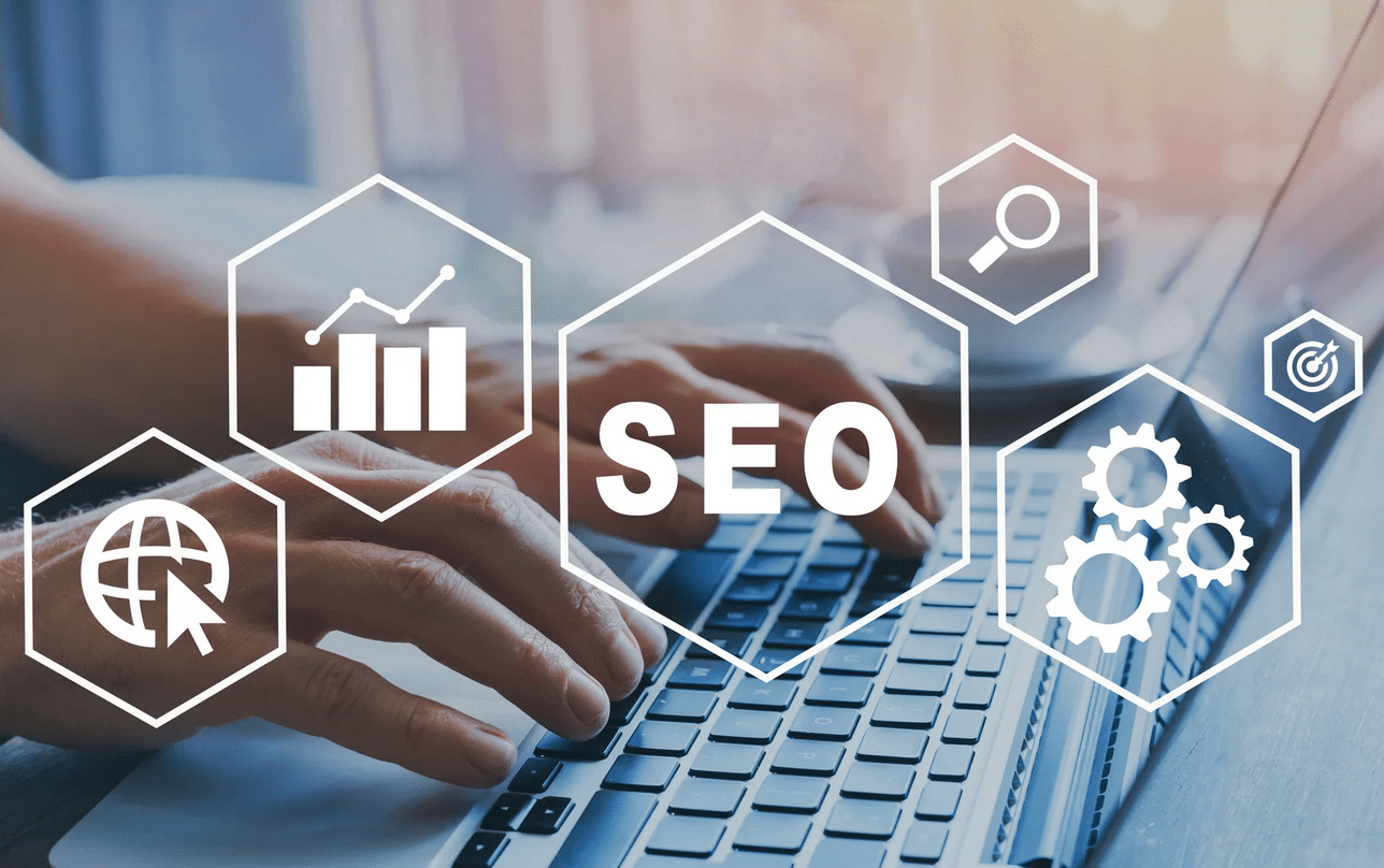 Hands typing on a laptop keyboard with overlaid icons for SEO, chart, magnifying glass, globe, and gears, representing digital marketing and search engine optimization concepts.