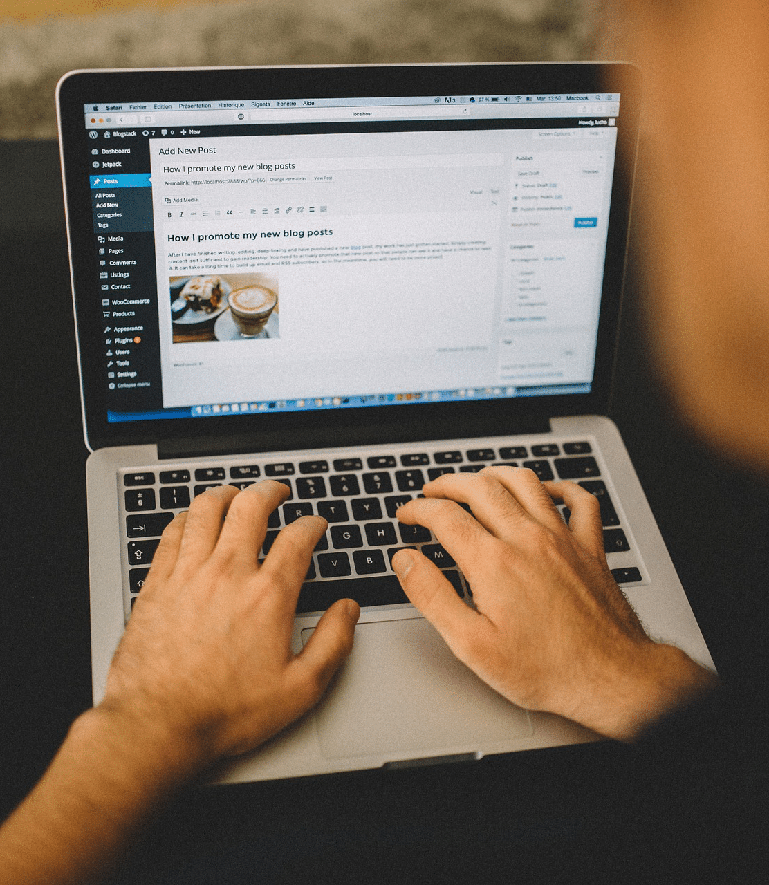 Person typing on a laptop, creating a new blog post in WordPress, with the blog editor and a photo of coffee displayed on the screen.