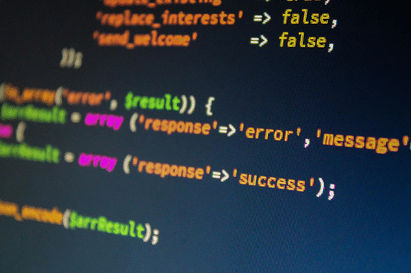 A computer screen displays colorful PHP code highlighting variables and functions for handling error and success messages.